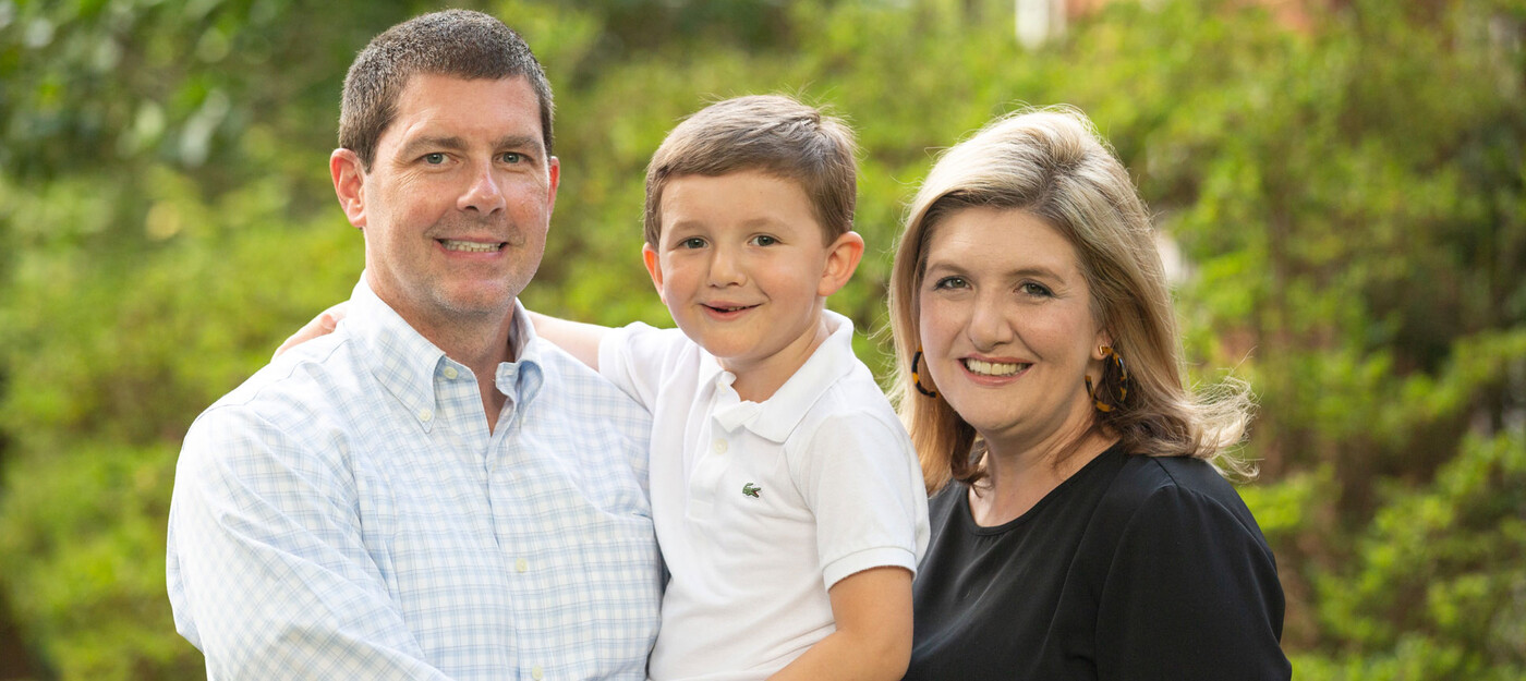 Scott, Jack, and Kristin Stroud smile outside their home in Raleigh. Both Kristin and her son Jack were born with a cleft lip and palate. A family outside their home