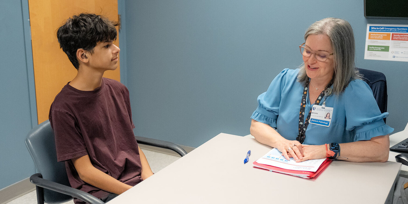 Andy Torres works with speech pathologist Megan Katz at the Duke Speech Pathology and Audiology Clinic. Andy Torres works with speech pathologist Megan Katz at a table