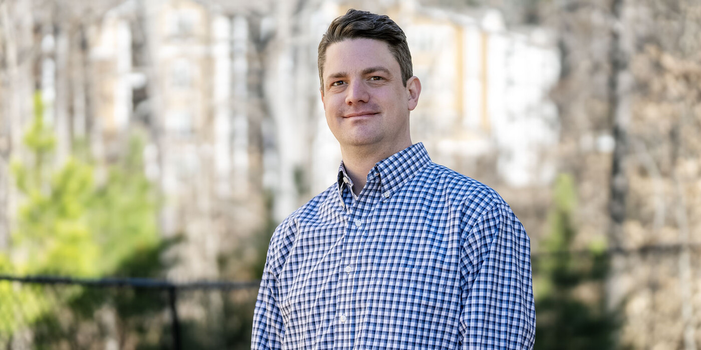 Chris Biggar stands outside his home in Durham, NC. Chris Biggar smiles outside