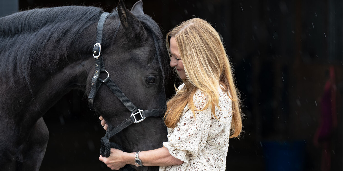 Kim Barnard holds her horse Johnny at her home in Roxboro, NC. Barnard said it was therapeutic to be able to heal around her horses and other animals. Kim faces and holds her horse's face
