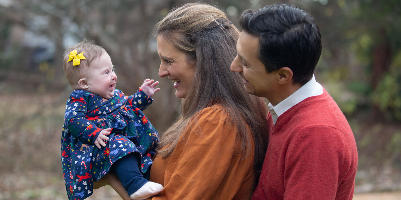 Izabel Westmoreland-Liao, left, is stronger than ever thanks to Duke’s Pediatric Cardiac Neurodevelopmental Clinic. Izabel smiles outside at her mom and dad