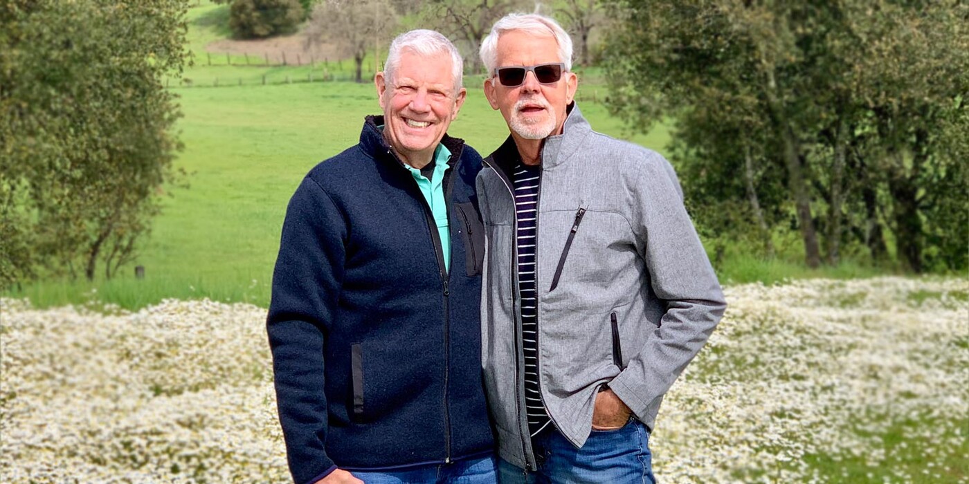 George Getz, right, and his husband in Sonoma, California. George Getz, right, and his husband stand in a field of flowers in Sonoma, California.